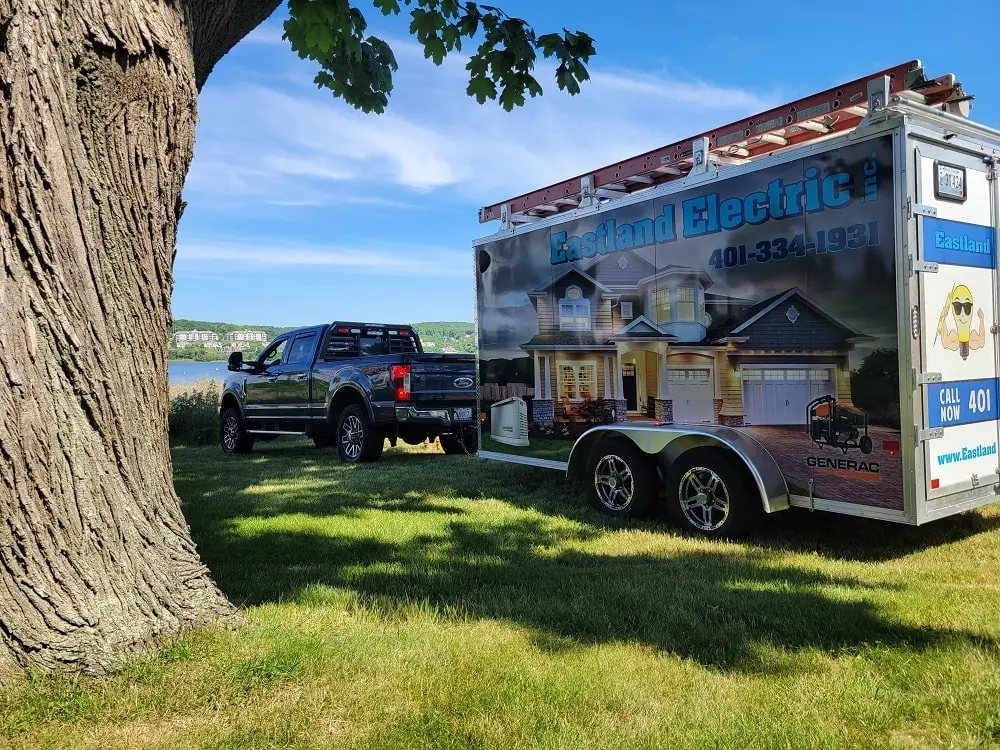 Eastland Electric truck with trailer in front of a pond in Rhode Island