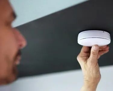 Fire alarm and carbon monoxide testing being done at a homeowner's house